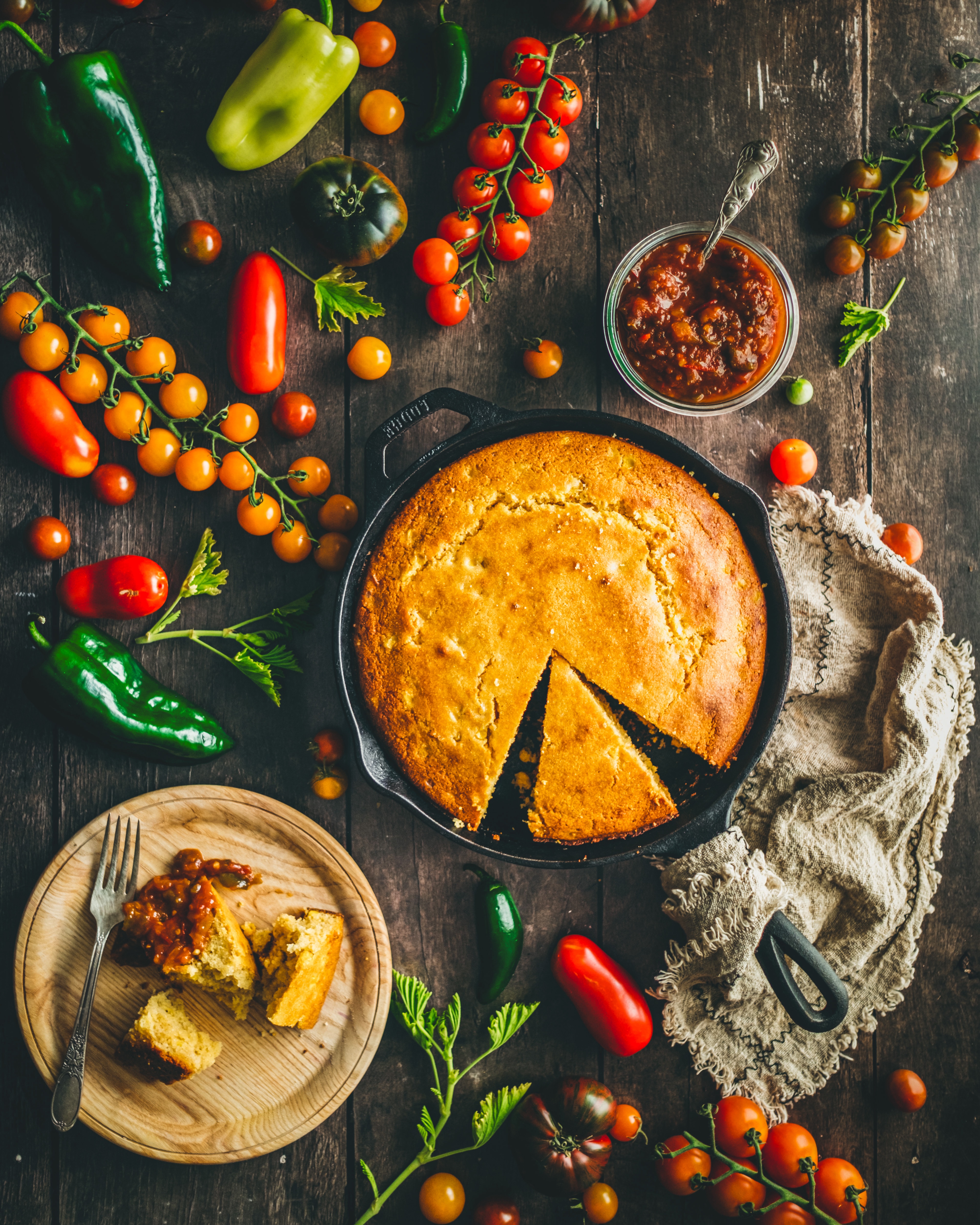 Skillet cornbread styled with tomatoes, peppers, and tomato pepper jam